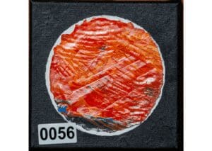 Abstract circular artwork with vibrant orange texture.
